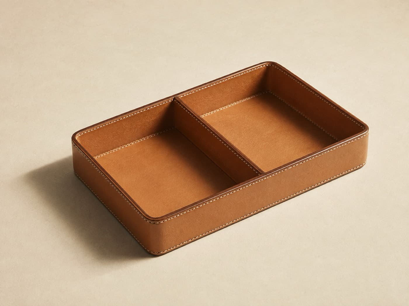 Bedside Valet with Divider — Two compartments, one stitched wall between them. Made for the nightstand, useful on a desk.
