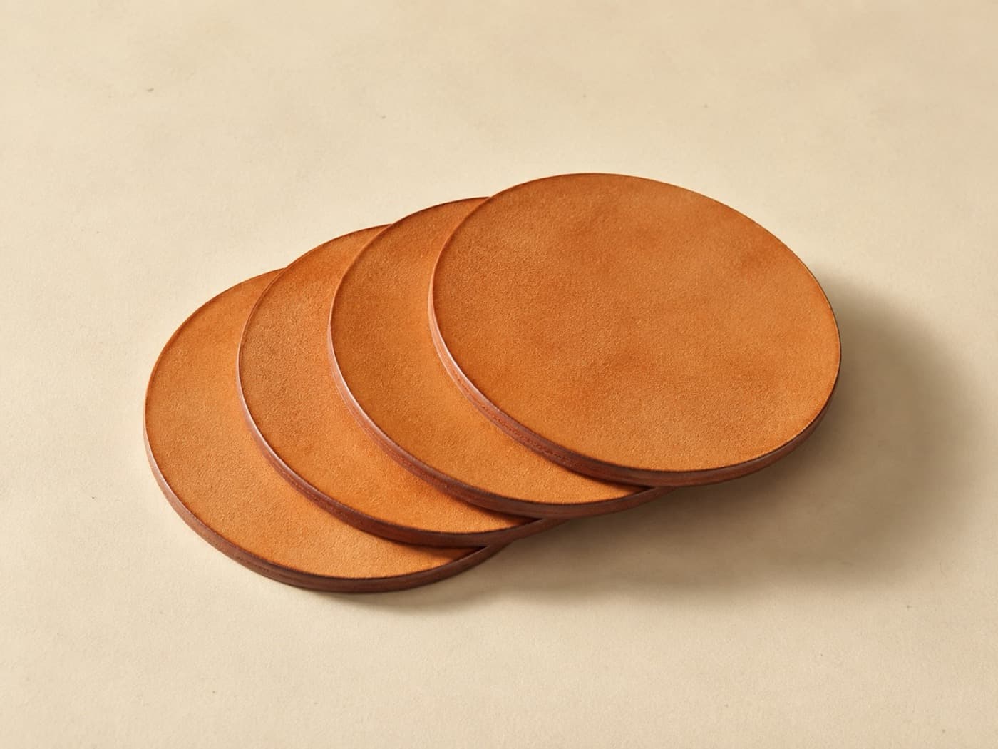 Coaster Set of 4, Round — Four discs at 4 mm — thick enough that the edge is the whole design.