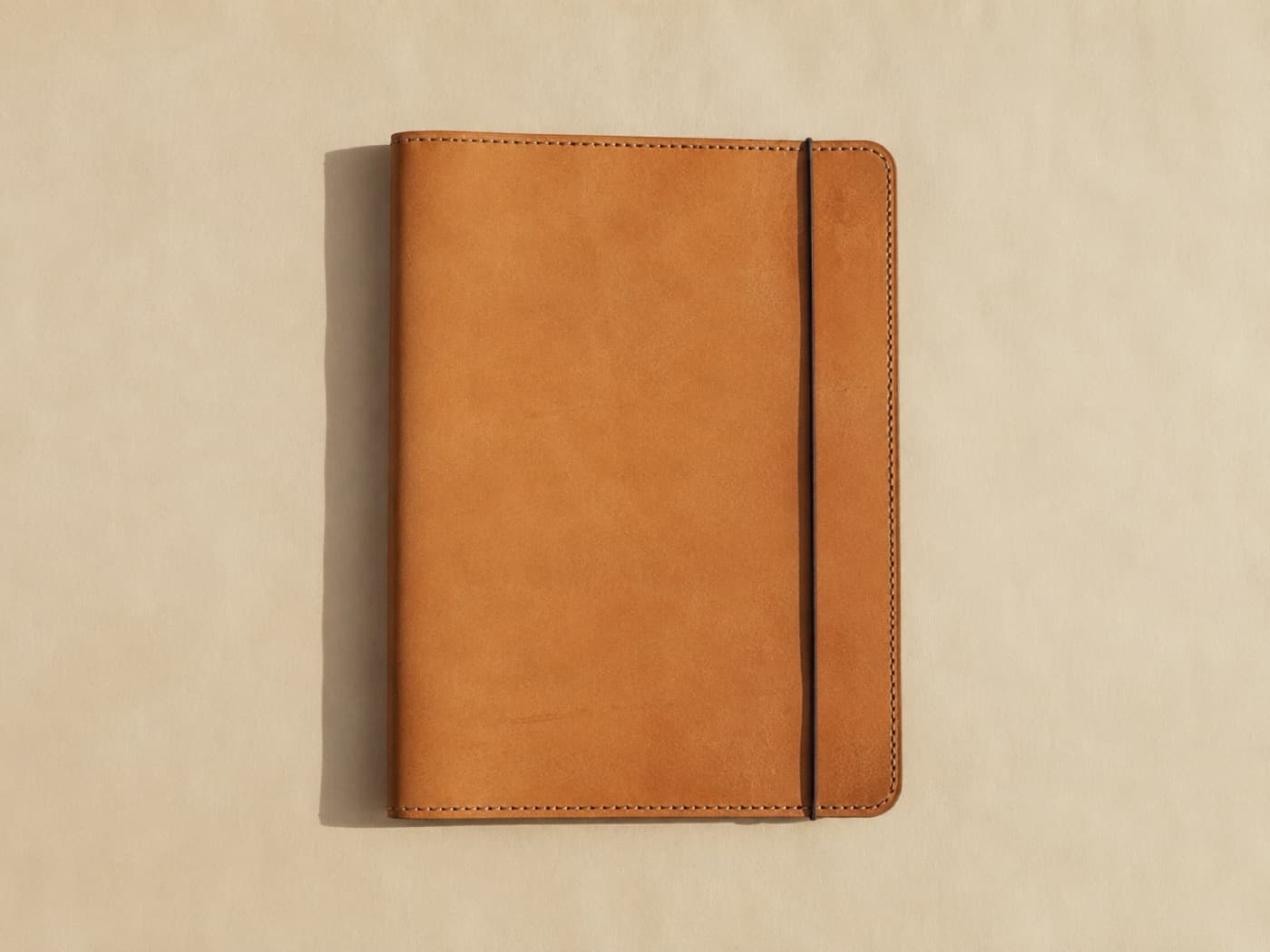 A flat A4 leather document folio with an elastic closure, seen from directly above