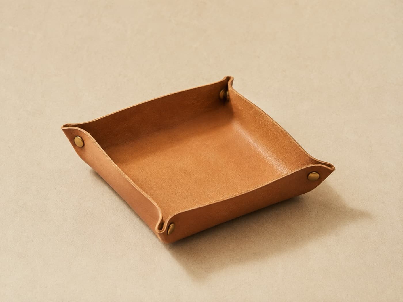 Valet Tray Square 20 × 20 — Four corners, four studs. Ships flat, becomes a tray in about five seconds.